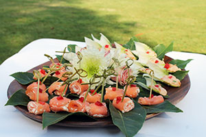 salmon rolls on a decorative platter